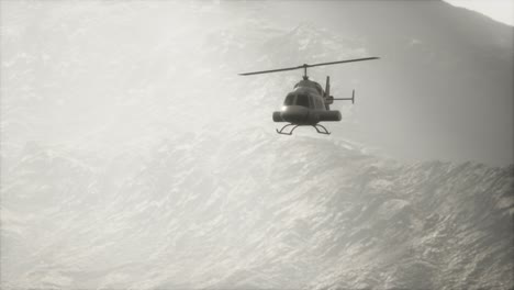 extreme slow motion flying helicopter near mountains with fog