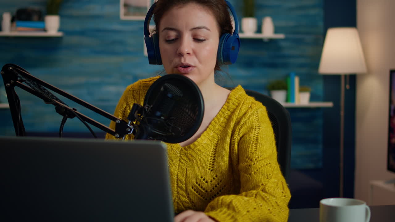 Vlogger looking at laptop while asking audience to subscribe on her channel
