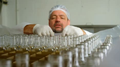 male worker holding bottles in factory 4k