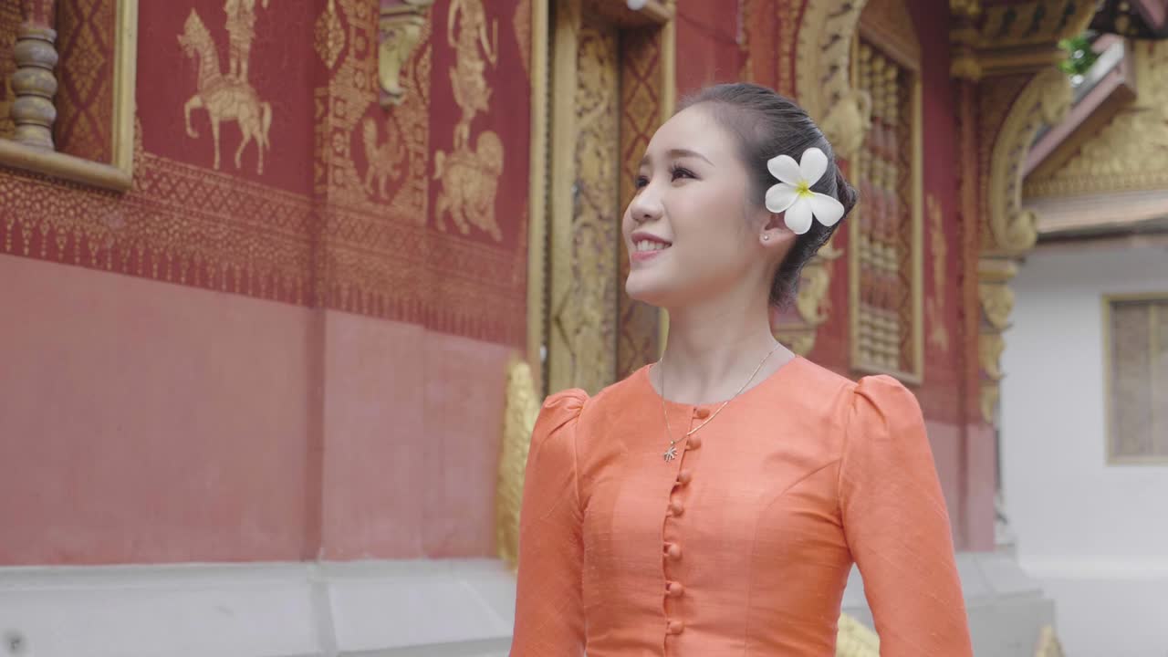Beautiful Girl In Lao Traditional Dress Costume Walking Near Temple, Slow Motion