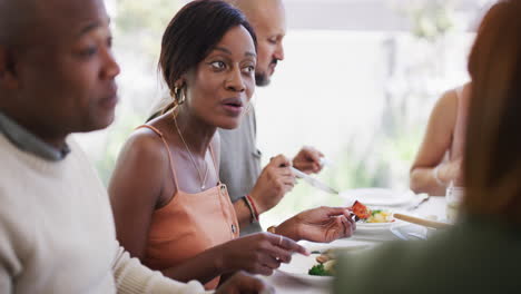 group of relaxed diverse friends enjoying a meal