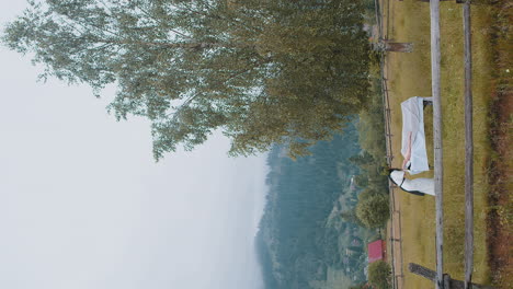 therapist female doctor making woman relaxing spa face massage outdoors in mountains field fantasy