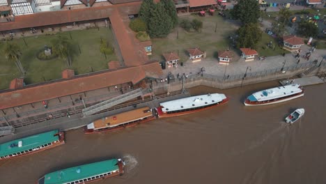 aerial view of a some boats docked revealing tigre river path and horizon at background
