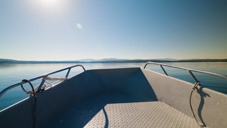 empty boat on a calm lake under a clear sky