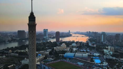 Aerial-perspective-of-Cairo-Tower,-a-solitary-concrete-structure-in-Cairo,-Egypt,-is-passed-by,-illustrating-the-concept-of-urban-prominence-and-architectural-significance