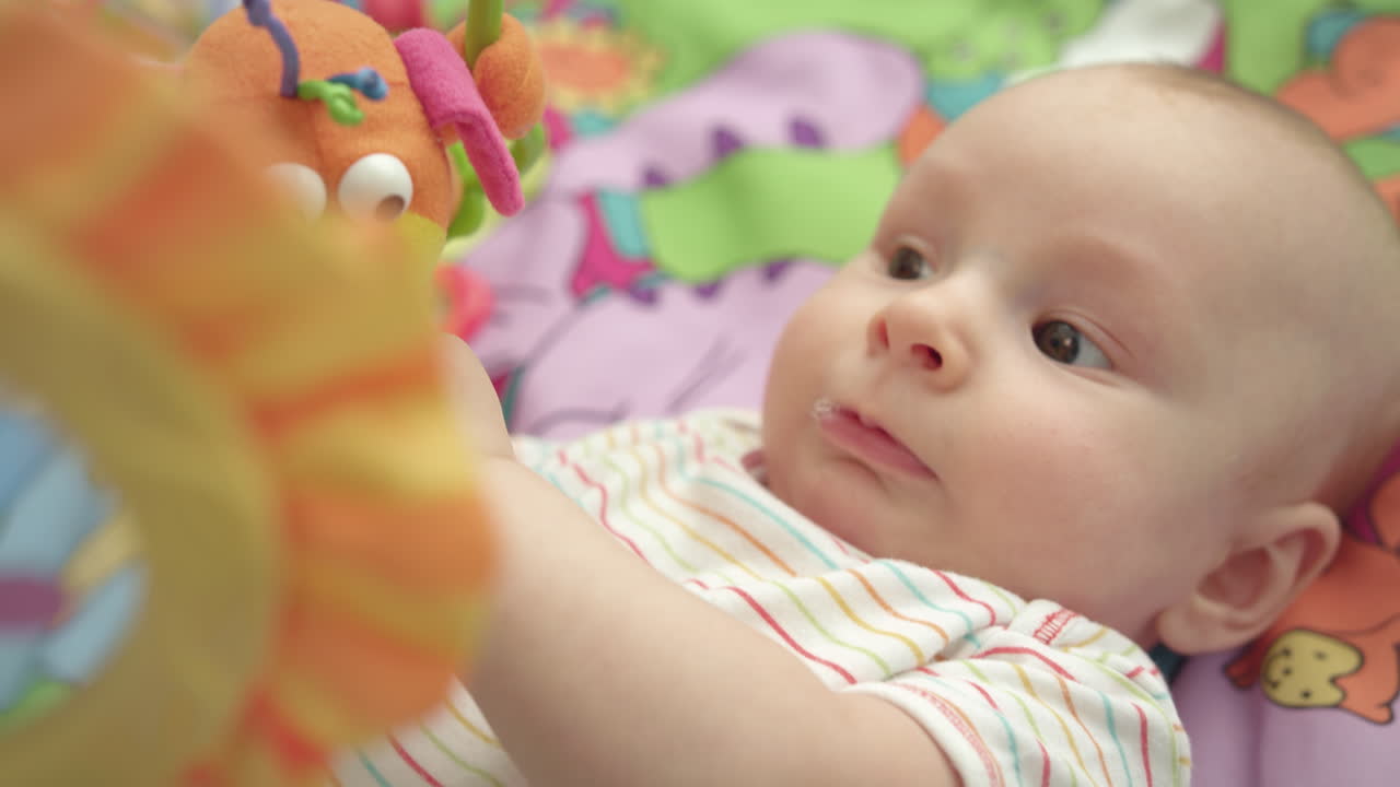 Portrait of little child looking toys. Close up of cute infant boy. Kid face