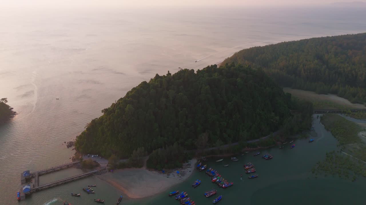 Secluded island with lush greenery, boats anchored by the shore, Laem Son National Park