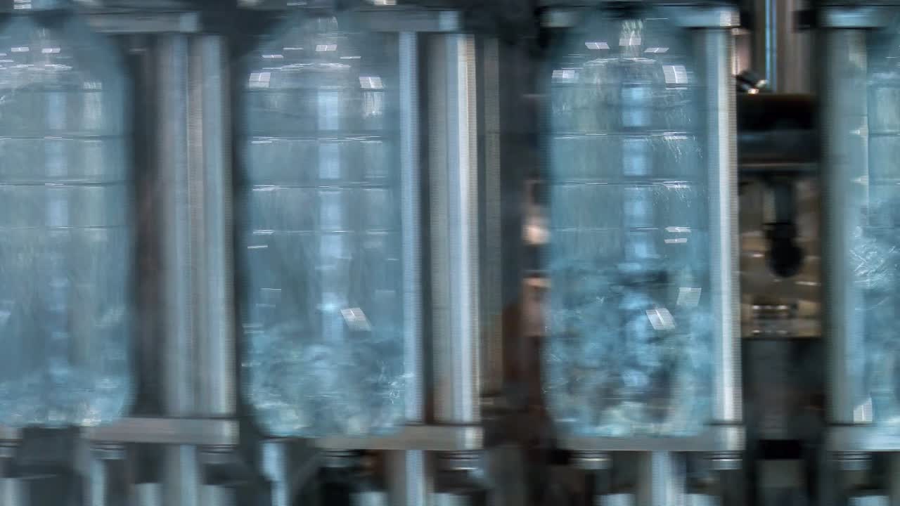 New plastic bottles on the conveyor belt of a drinking water plant
