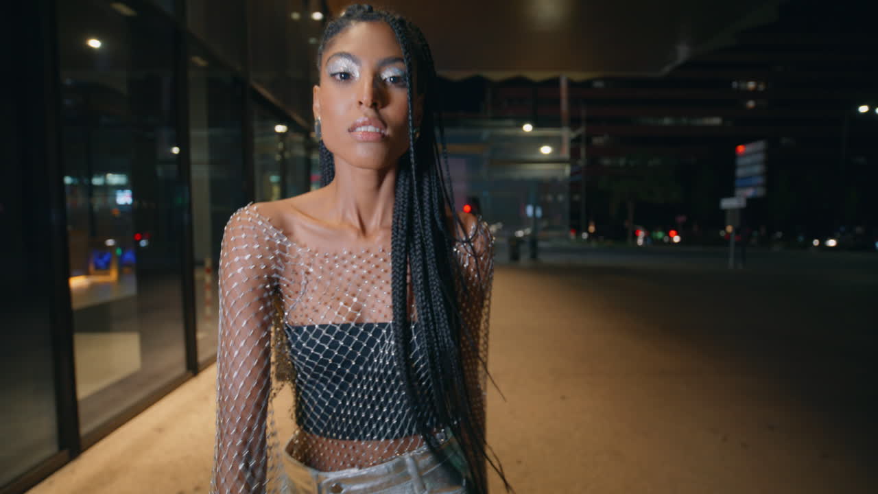 Seductive woman stretching hand camera posing night city portrait. Urban vibe