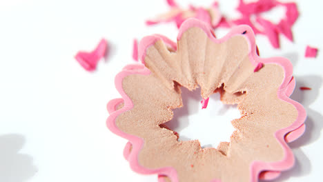 pink color pencils shavings on a white background