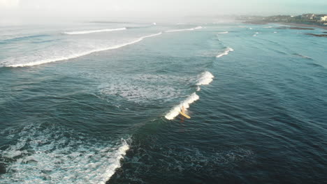 surfing in batu bolong at sunrise