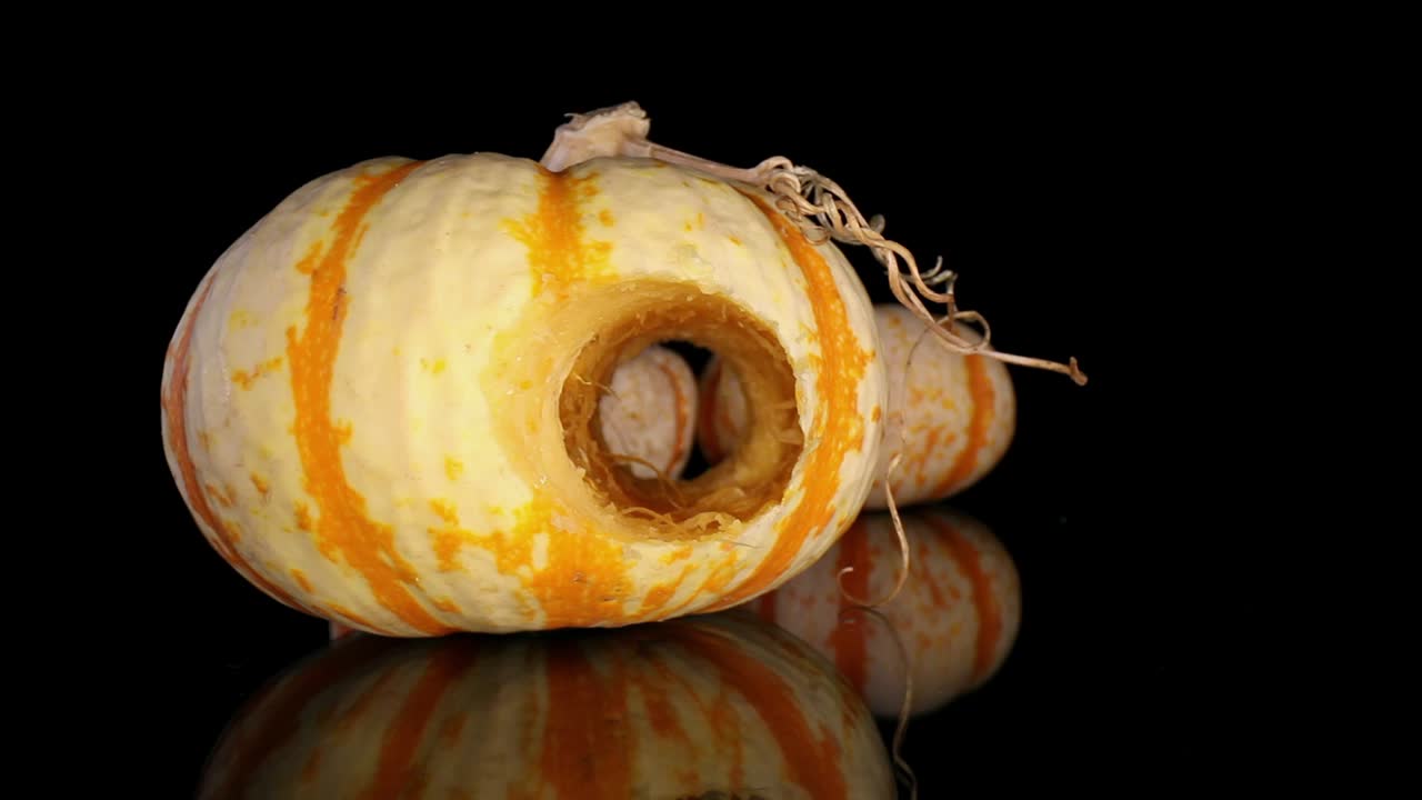 A unique look at the core of a gourd - starting with one decorative gourd in view and two others in background, pushing into the core of the center gourd - macro view of interior of the gourd