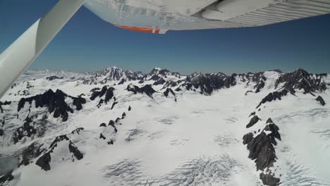 slowmo - snow capped rocky mountains in aoraki mountain cook national park, southern alps, new zealand from helicopter scenic flight