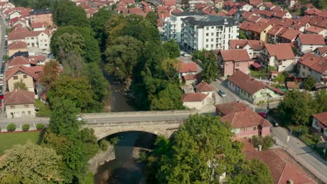 aerial view of cars passing by the stone bridge in the town of ivanjica in serbia