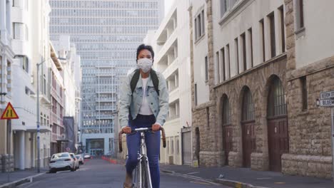 Woman-riding-on-her-bike-while-wearing-medical-coronavirus-mask