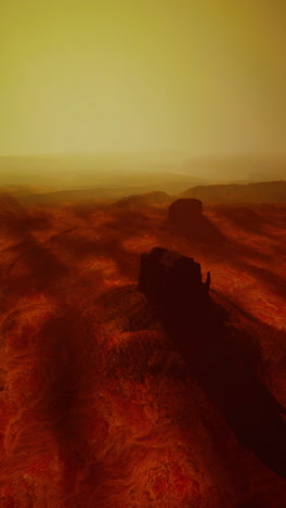 a vast desert landscape with dunes sparse vegetation and a clear sky