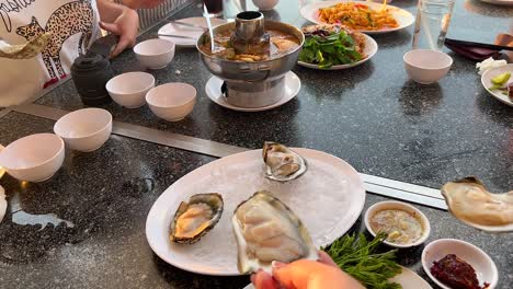 friends enjoy fresh oysters in pattaya, thailand