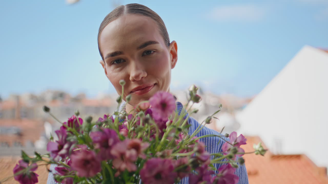 Coquettish girl hold daisies posing view balcony closeup. Lady looking camera