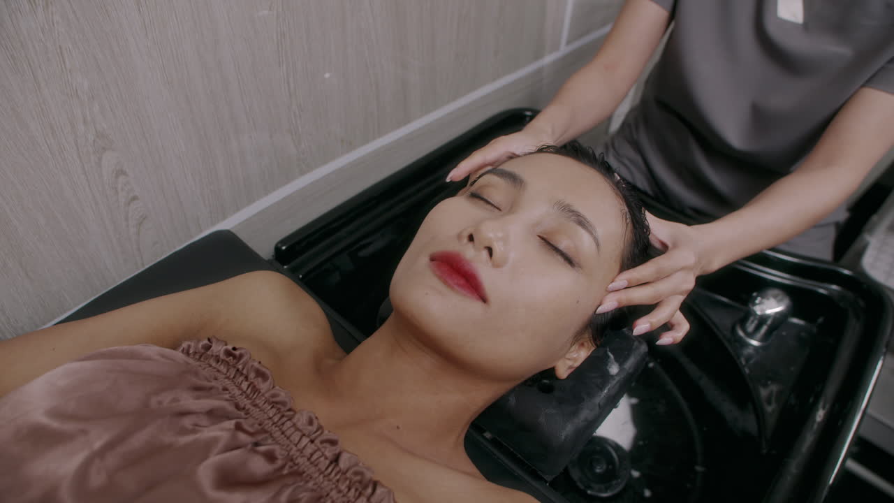 Beauty Salon Worker Doing Head and Temple Massage to Female Client