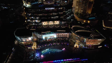 aerial view rising away from the colorful iconsiam mall, evening in bangkok