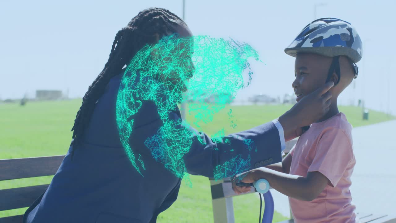 Father lifting helmet onto son's head in park, securing straps while teal globe pulsing for health