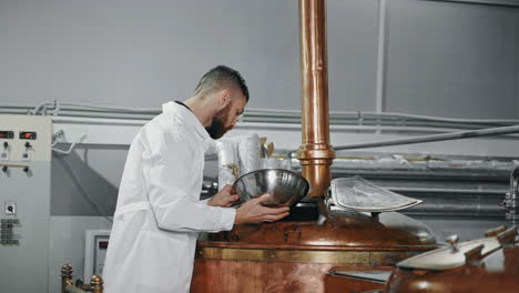 brewer inspecting equipment in brewery