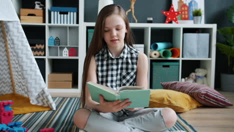 girl reading a book in a cozy playroom