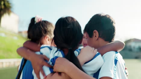 Hug,-happy-and-children-on-a-field-for-soccer