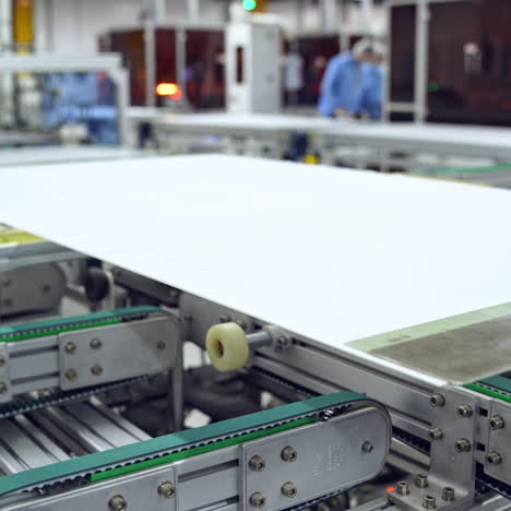 process of making clean solar panels inside a modern factory. automated machine for producing solar cells. robotic equipment of contemporary plant.