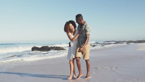 african american couple walking seaside