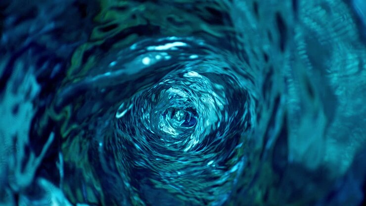 Water Vortex Circulating Clockwise In Slow Motion, Top View From Inside of the Blue Whirling Liquid