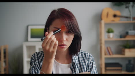 woman applying makeup