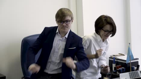 two coworkers dancing in the office