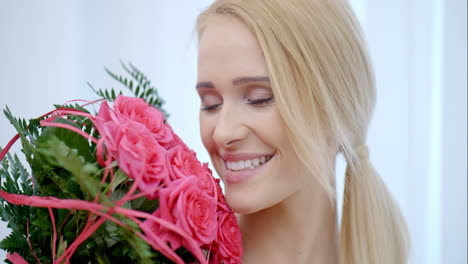 Happy-Pretty-Woman-with-a-Bouquet-of-Pink-Roses