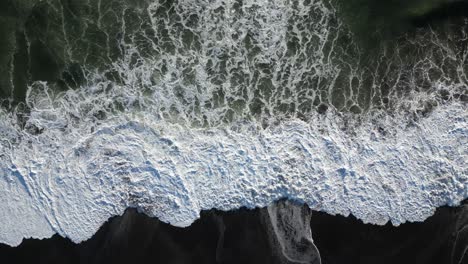 Birds-eye-view-of-crashing-waves-in-Tabanan,-Bali-early-in-the-morning,-aerial