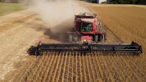 Modern-combine-harvesting-soy-beans-in-Michigan,-USA,-aerial-view-from-front