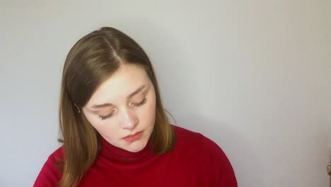 female young student listening intently whilst looking directly into camera