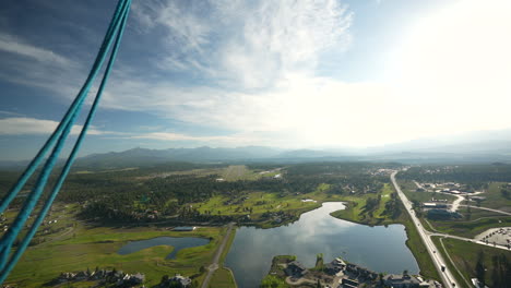 view from hot air balloon basket, idyllic green landscape of colorado countryside on sunny summer morning