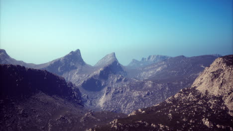 Majestic mountain range embraces serene sky at dawn