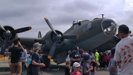 airshow spectators at boeing b-17 flying fortress static display slomo