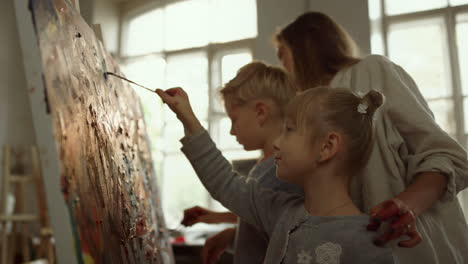 creative family spending time in art studio. female artist drawing in workshop.