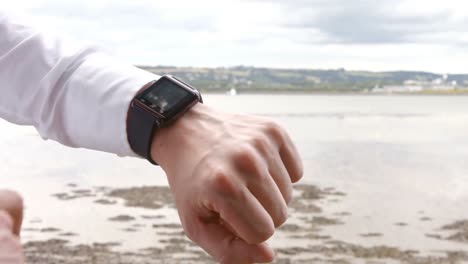 close up of a man using his smart watch