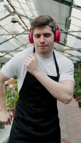 man dancing in a greenhouse