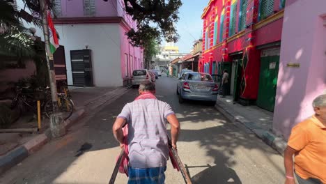 rickshaw puller on a colorful street in kolkata, india