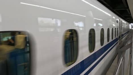 a train accelerates through a subway station