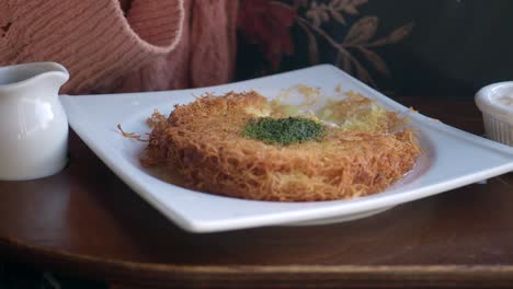 person eating kunafa dessert