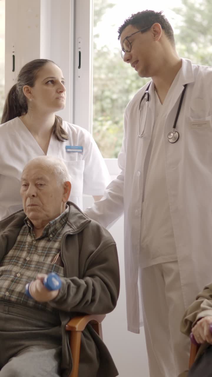 Distracted doctors talking while senior people exercising in geriatric