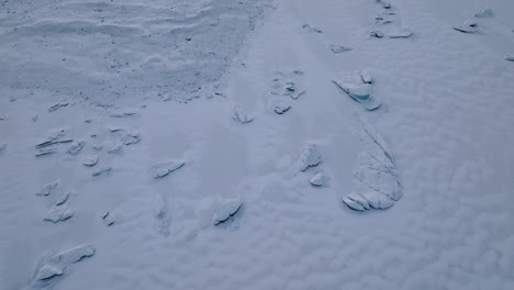 aerial landscape view over iceberg frozen inside skaftafellsjokull glacier covered in snow, iceland