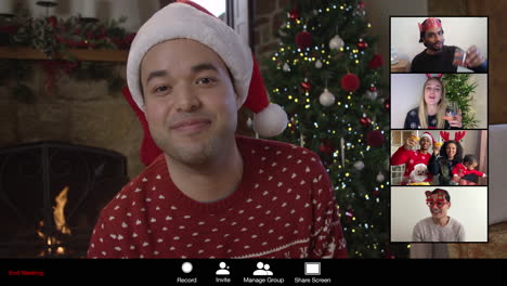 man cheers’ friends on christmas video call