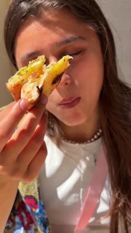 woman and girl eating pizza